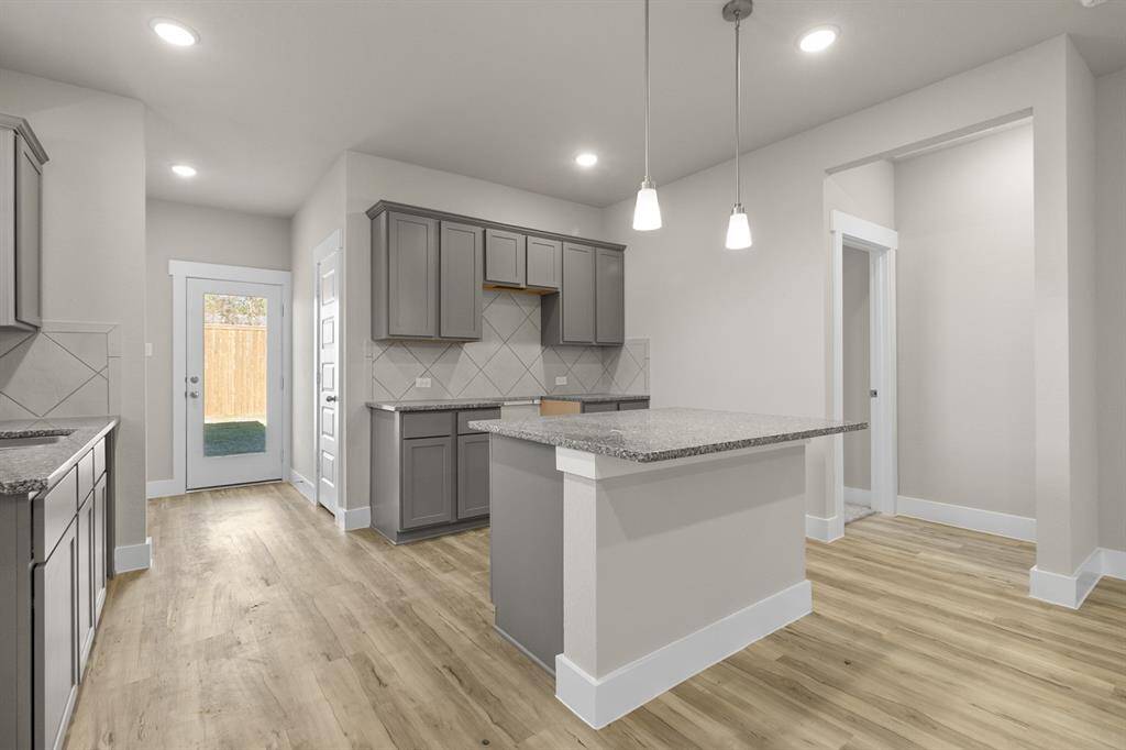 The sleek countertops, with their soft veining, invite you to gather around, whether for a quick breakfast or a weekend feast with friends. Microwave, Dishwasher, Stovetop range are included, just not pictured.