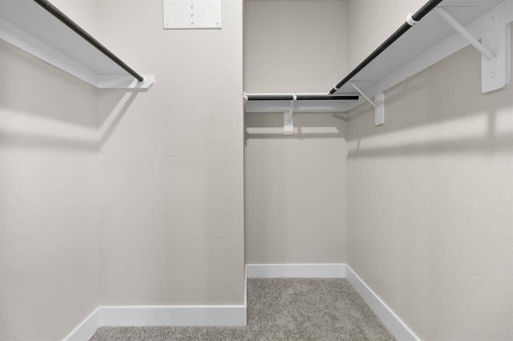 A stylish walk-in closet awaits, providing ample storage for your wardrobe and a little extra room for those cherished items.