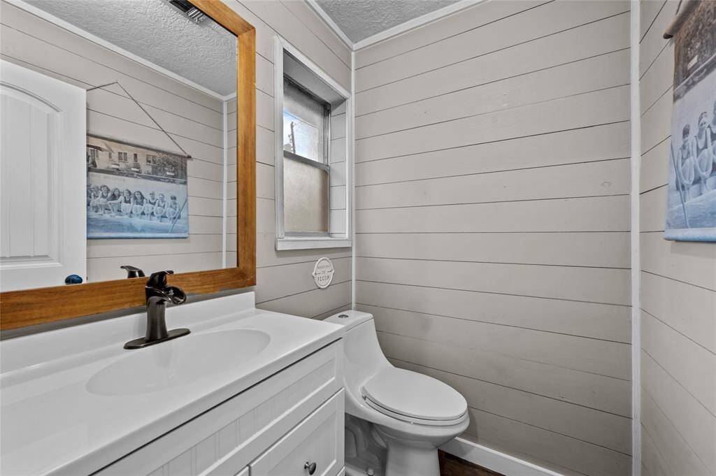 Half bath off utility room.  Convenient for pool days!