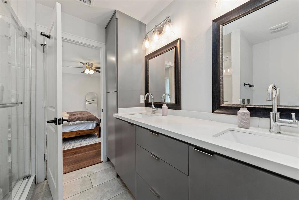 The primary bathroom features tons of storage, a walk-in shower, and a generously sized primary closet with custom built-in's
