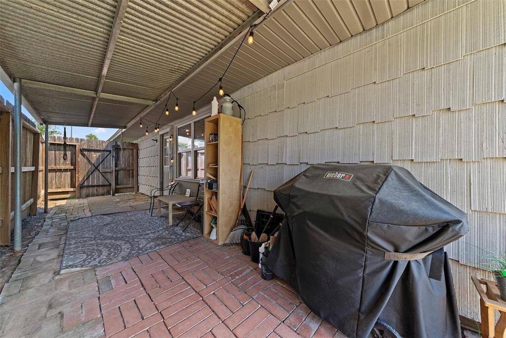 With additional access to the front of the property and covered trash bin area on the other side of the fence.