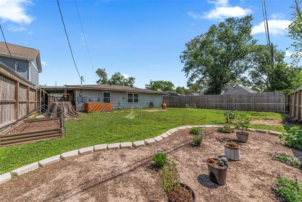 ...is this backyard! ?? You'll have plenty of room for the fur babies and kiddos to run free, and bonus raised garden beds to plant some veggies, this is the PERFECT place to call your next home!