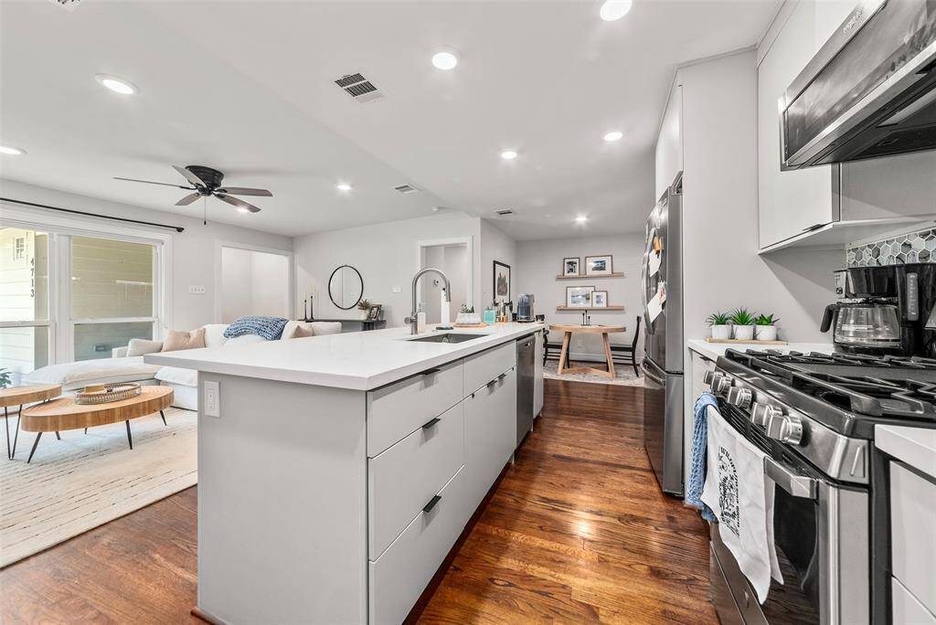 Gas range, stainless steel appliances, plenty of counter space, included refrigerator, and soft-close cabinetry
