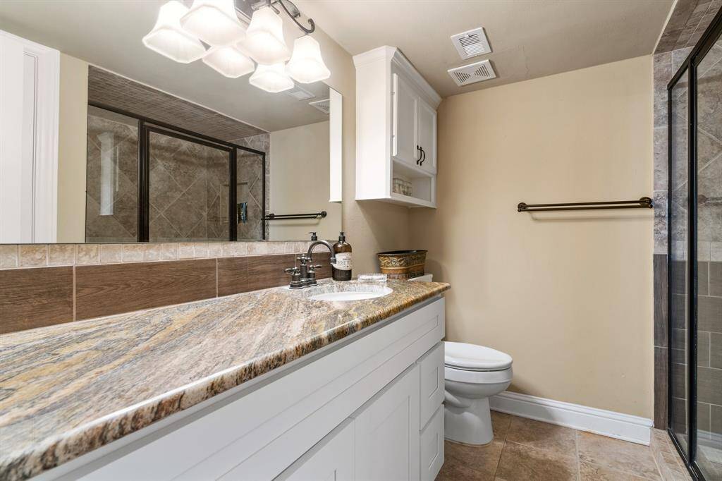 Primary Bath with glass enclosed oversized shower.