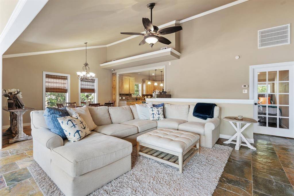 High ceilings enlarge the feel of this open floor plan, The glass door leads to a 4th bedroom with private bath which could be a great study as well. Pretty slate floors through-out the living areas.