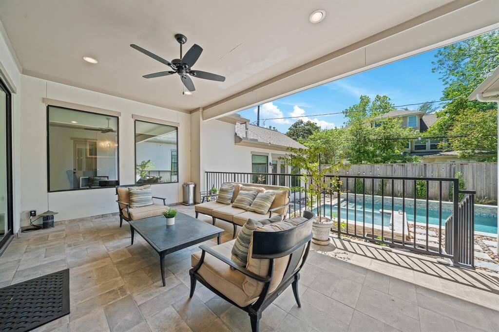 The backyard offers a covered patio with a summer kitchen spcae, a resort-style pool and spa.
