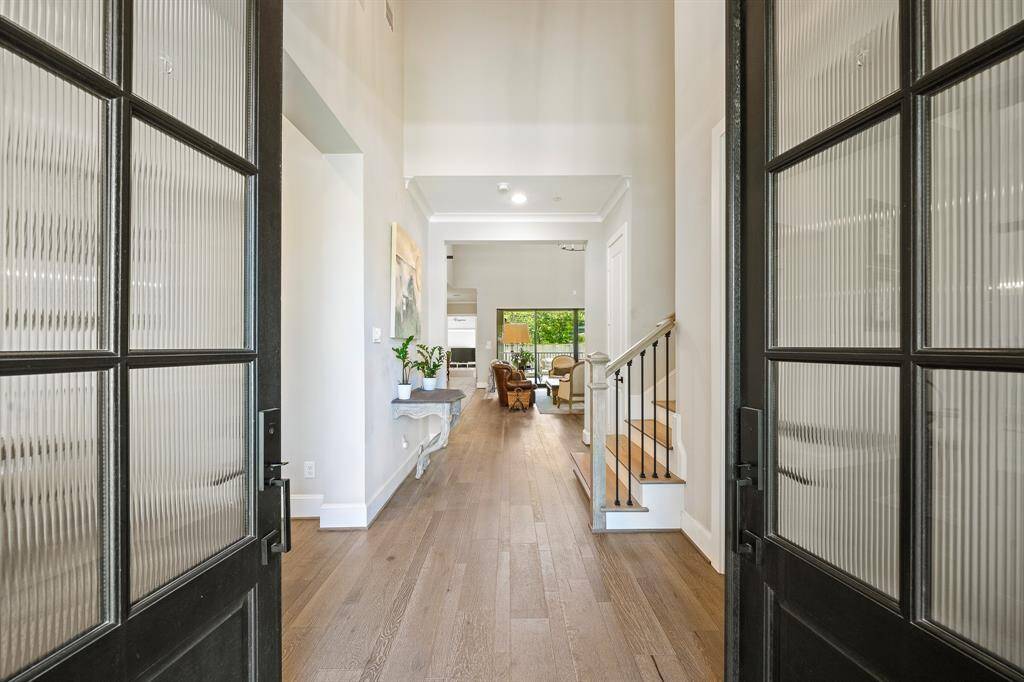 The custom iron double doors are awesome! The fabulous home features a dramatic high ceiling entrance.