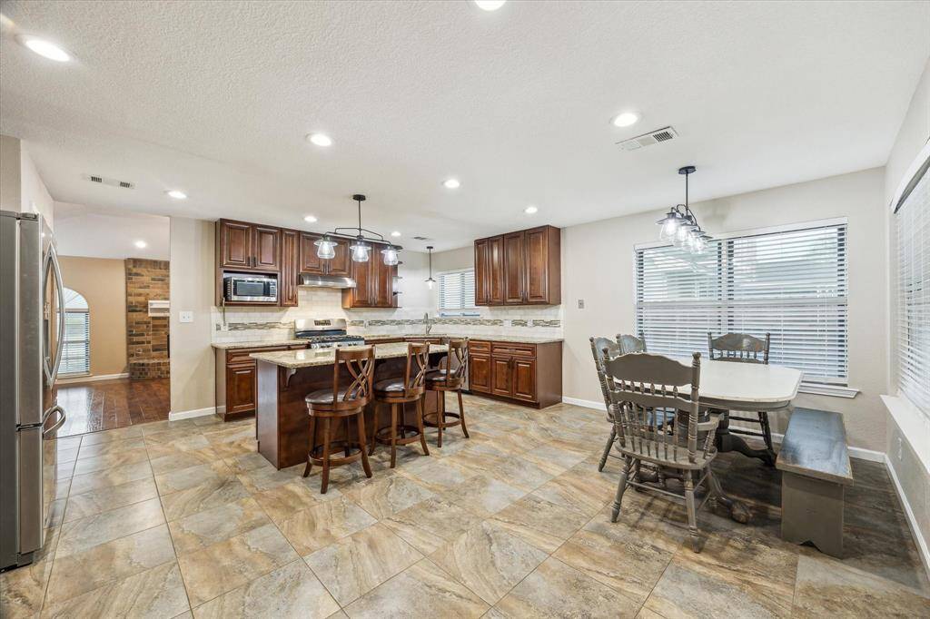 The kitchen is located just past the living room and opens to a hallway leading back to the three bedrooms.