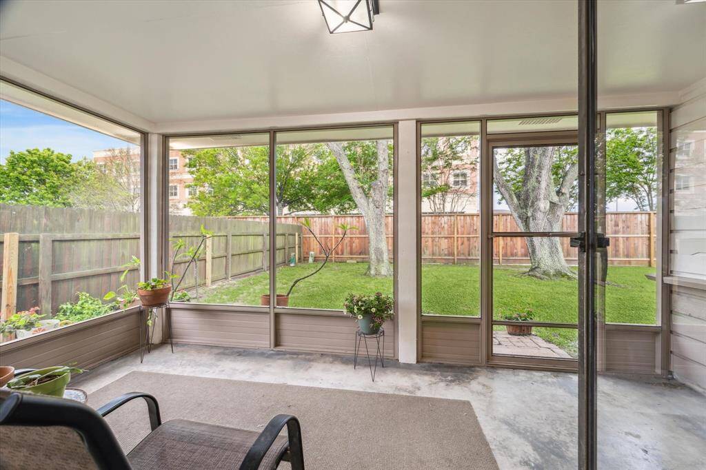 Here is the view from the screened-in porch to the fenced-in backyard with mature trees. It's a perfect space for relaxation and enjoying the outdoors while being indoors.