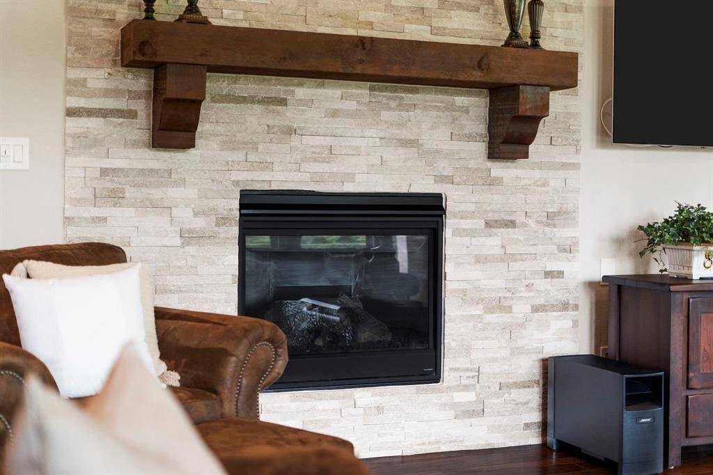Gas log fireplace and cedar mantel