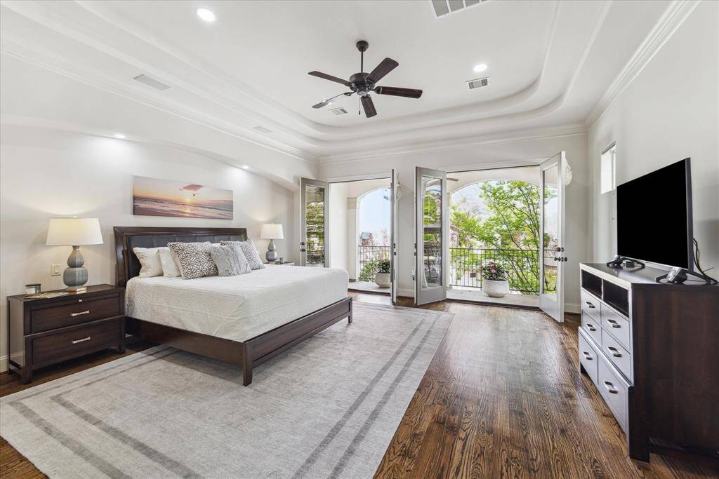 Expansive primary suite located on the second floor with double french doors opening to the large covered balcony that fills the room with natural light and great views.