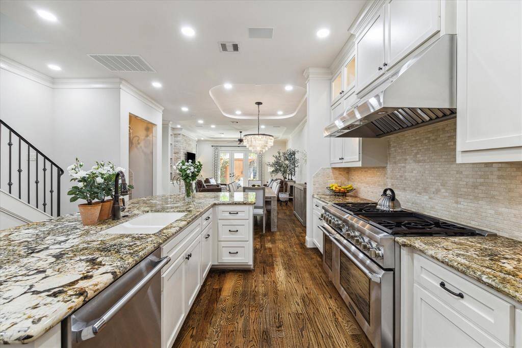 Kitchen offers expansive granite countertops and island and plenty of cabinet spaces.