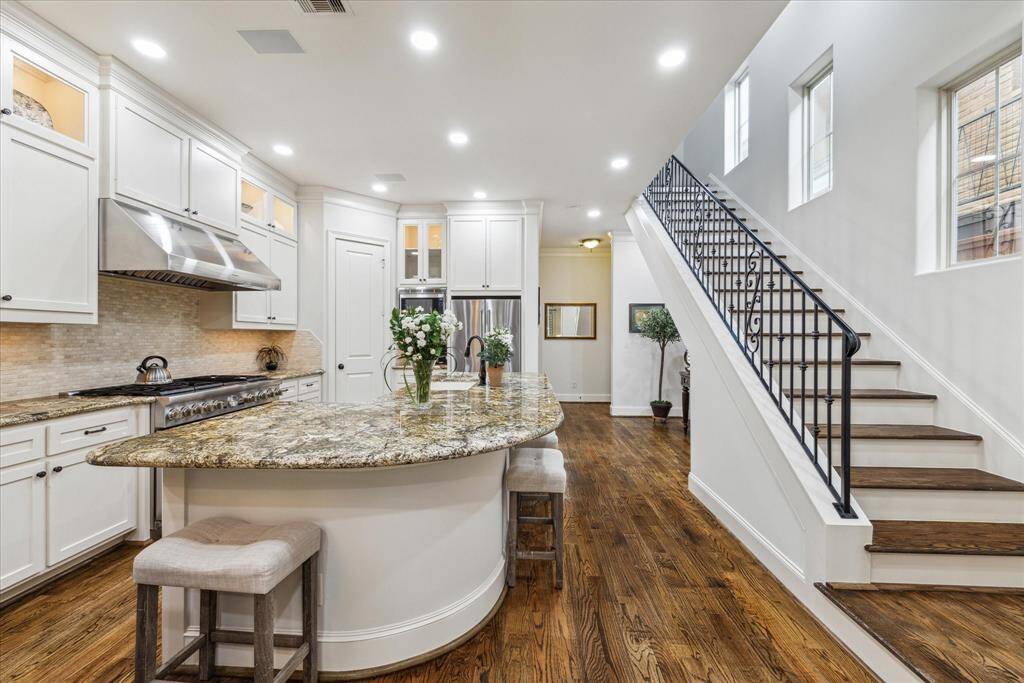 An expansive granite island that comfortably accommodates seating for six or more.