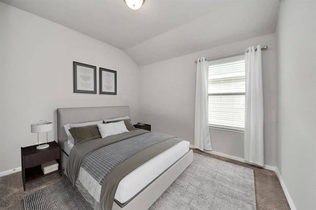 Secondary bedroom features awindow and plush carpet.