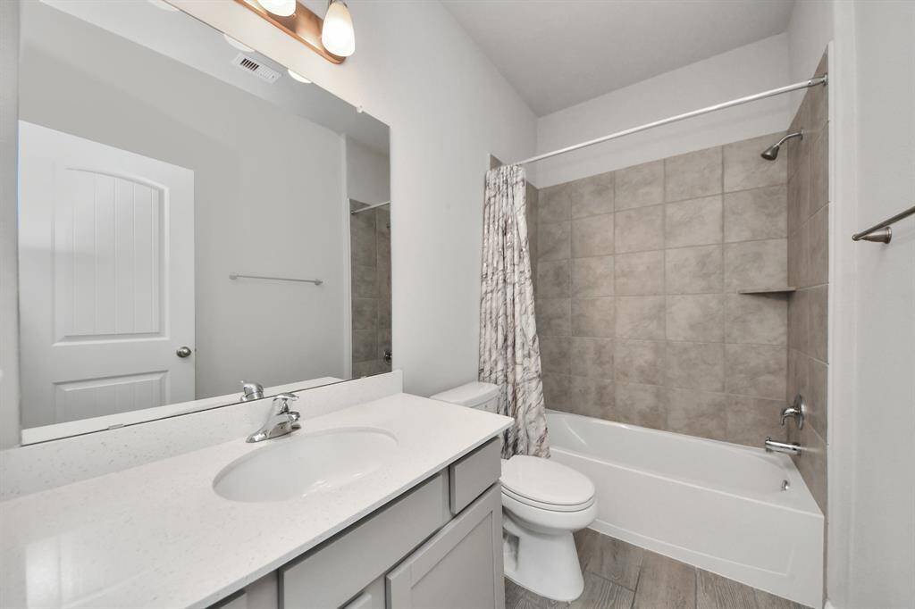 Secondary bathroom features atub/shower combo and long vanitywith plenty of counter space.