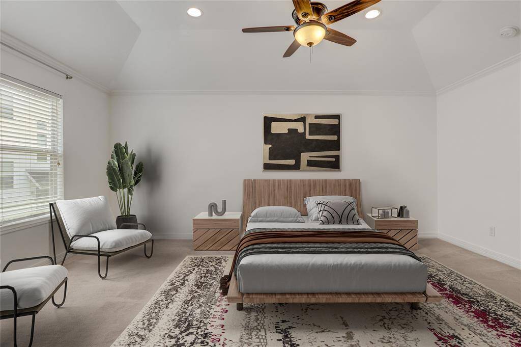 Another view of the primary bedroom highlights its generous size and vaulted ceiling. The natural light from the window makes this room a bright and peaceful retreat to start and end your day. This photo is virtually staged.