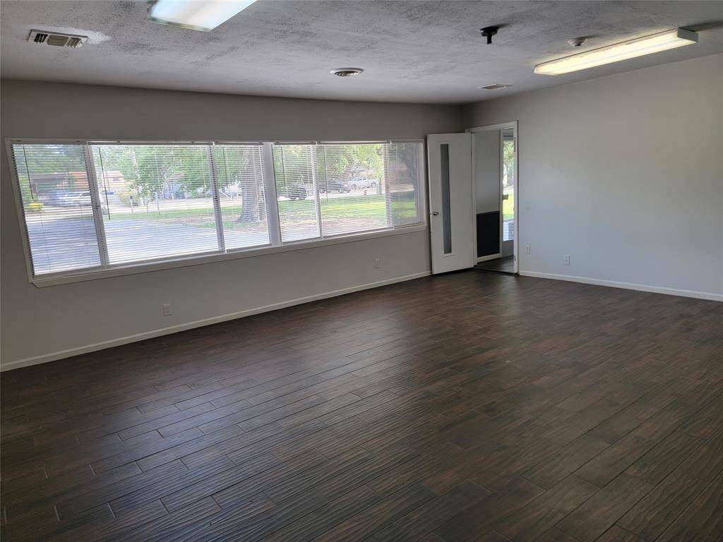 Large room looking at entry door.