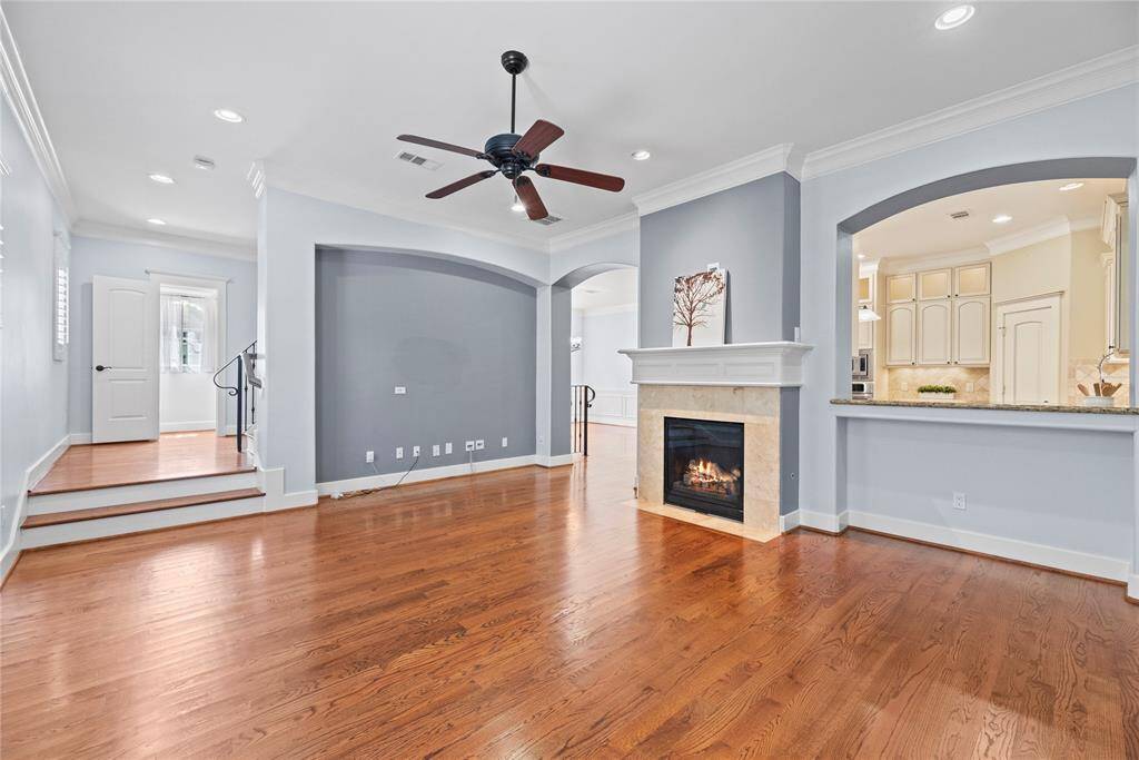 The living room, adjacent to the kitchen, offers a comfortable and inviting space for relaxation and socializing. Whether it's watching TV, reading a book, or simply enjoying the company of loved ones, everyone can feel connected and included in the activities happening throughout the space