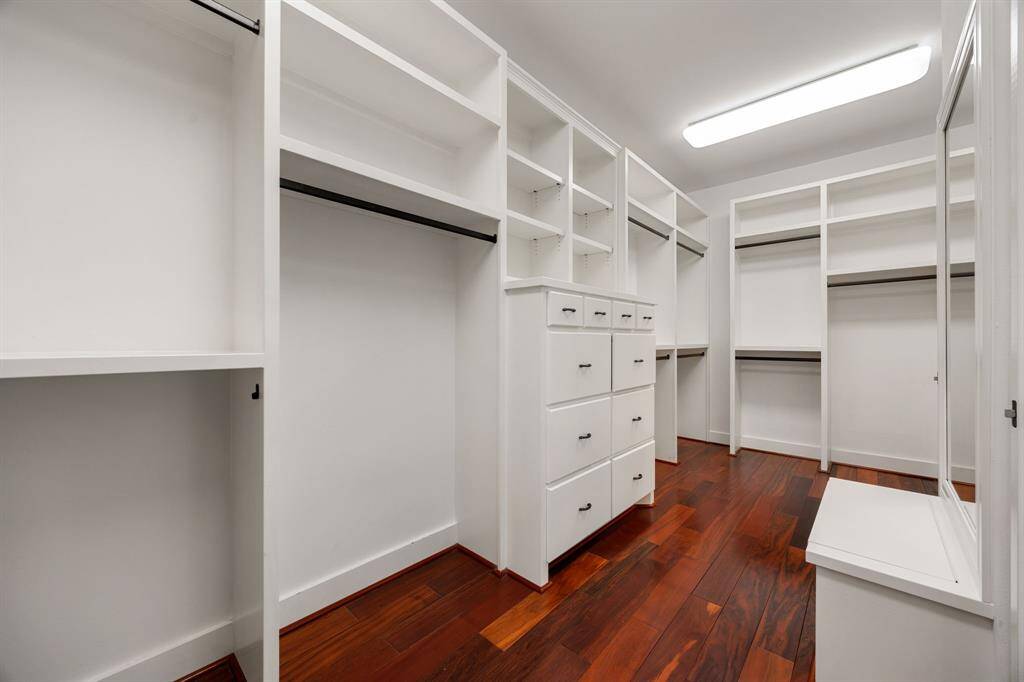 The primary walk-in closet has room for all his and her clothes.