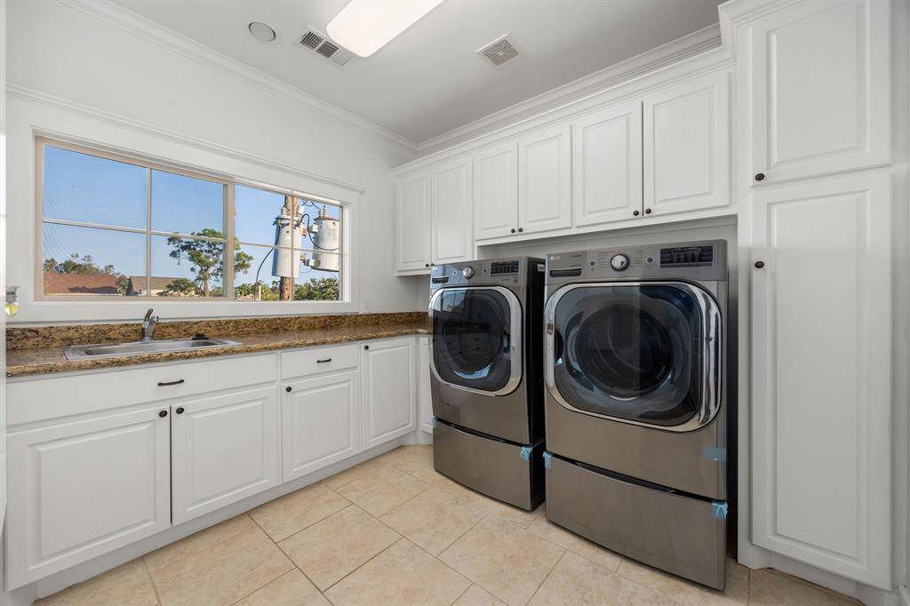 You have to see the utility room. It's so big, with tons of cabinet space and additional sink! Comes with washer/dryer.