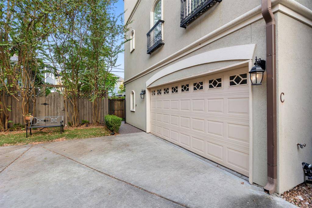Your gated side entrance is beautifully landscaped and adds a touch of natural beauty.