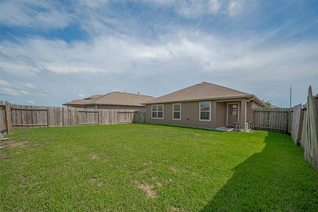 The home features a covered patio area. Ideal for outdoor activities and relaxation.