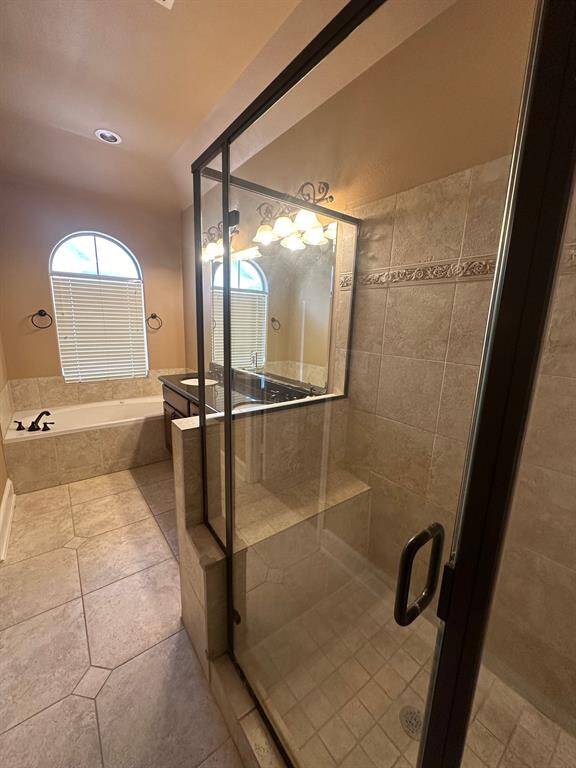 primary bath with large walk-in-closet