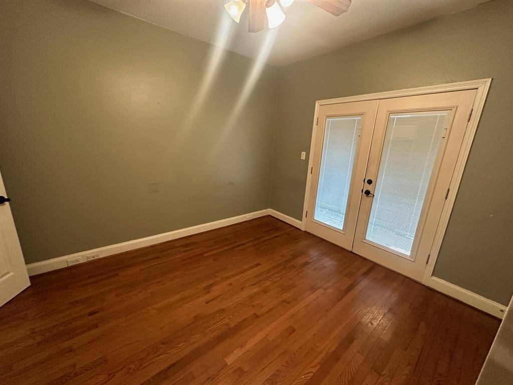 Third bedroom with wood flooring