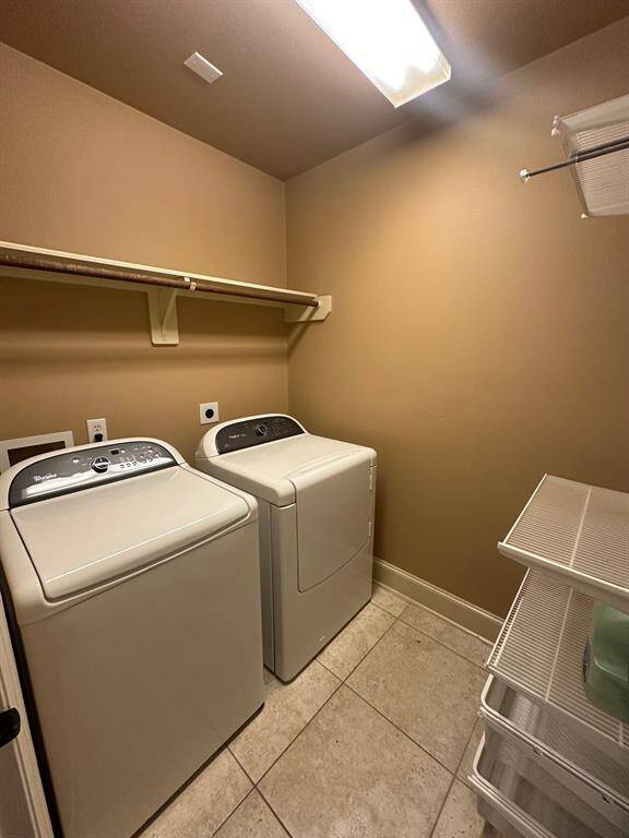Utility room in home with washer and dryer included