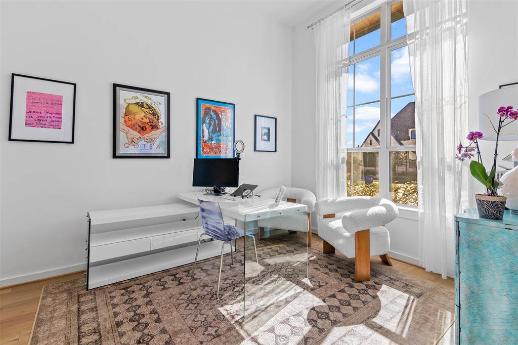 Bright and white home office with high ceilings and large windows that provide lots of natural light to get you through the work day!