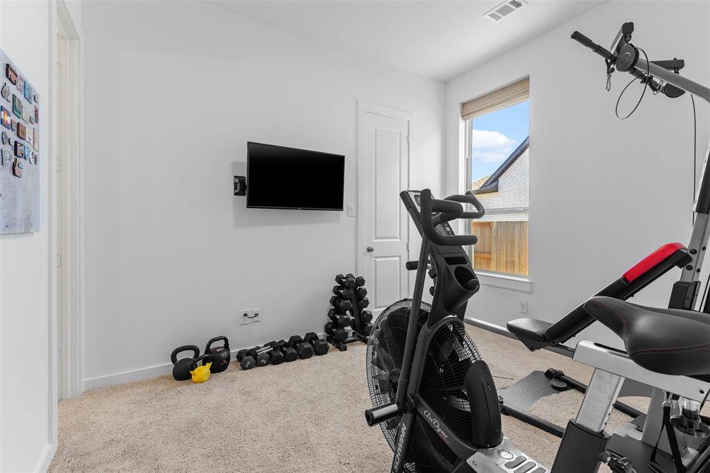 Another primary bedroom that has an en suite bathroom.  Room is currently set up as a gym.