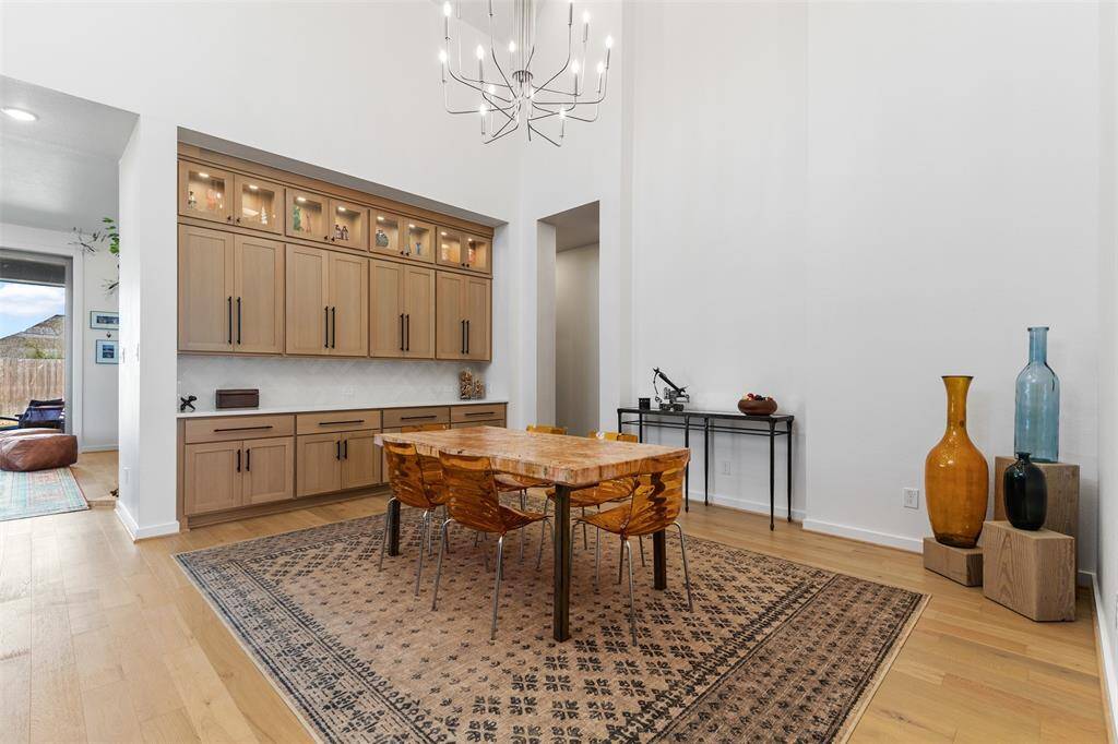 Alternate view of dining room with high ceilings and plenty of storage.