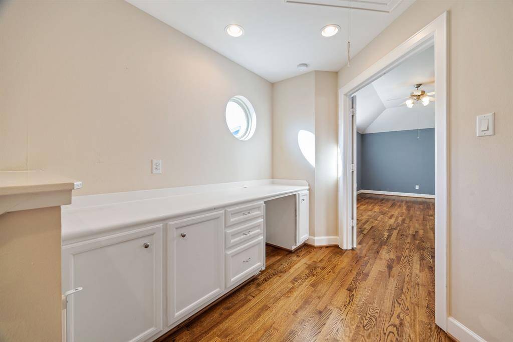 Third floor landing with built-in cabinetry and desk area