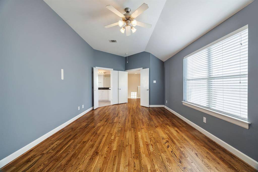 Huge primary bedroom with high ceilings and tons of natural light