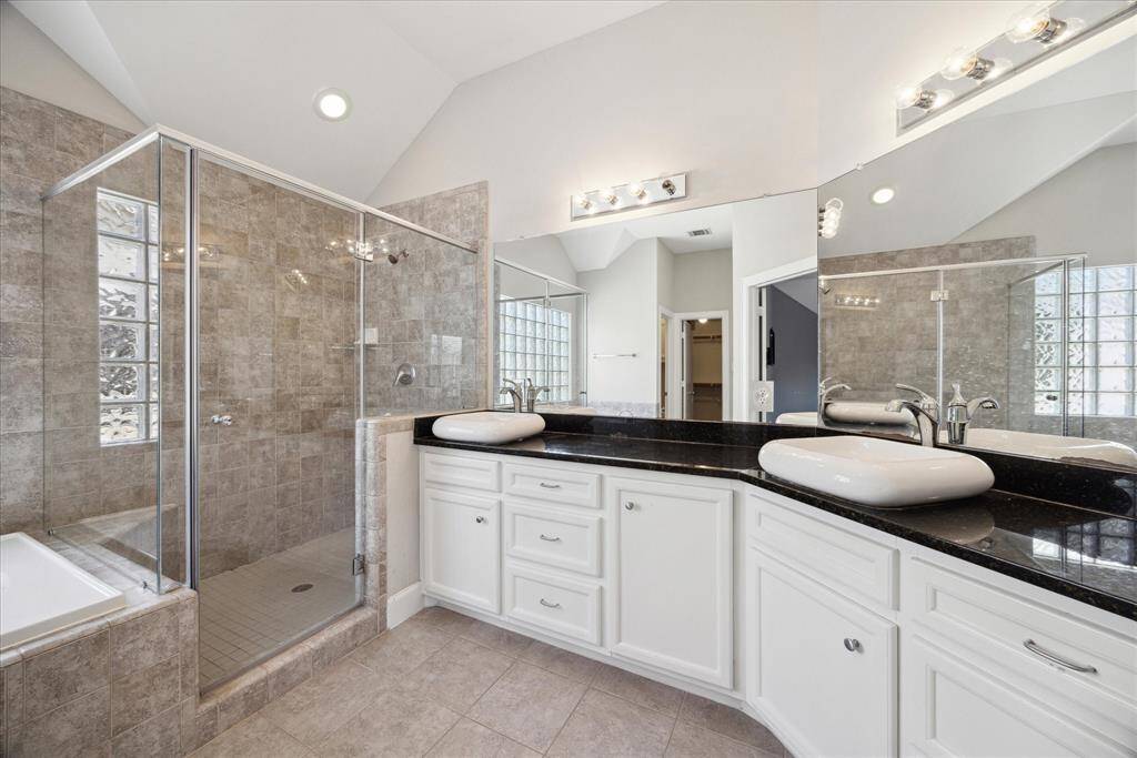 Double sinks, tub and separate walk-in shower in this wonderful primary en-suite bathroom