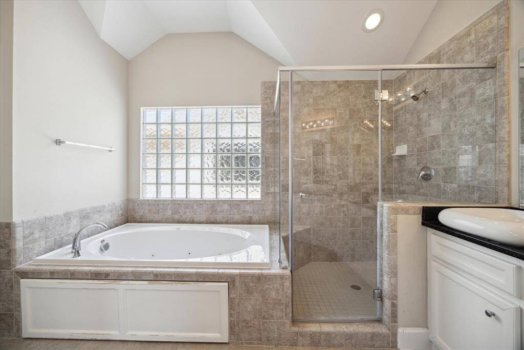Additional view of the tub and walk-in shower