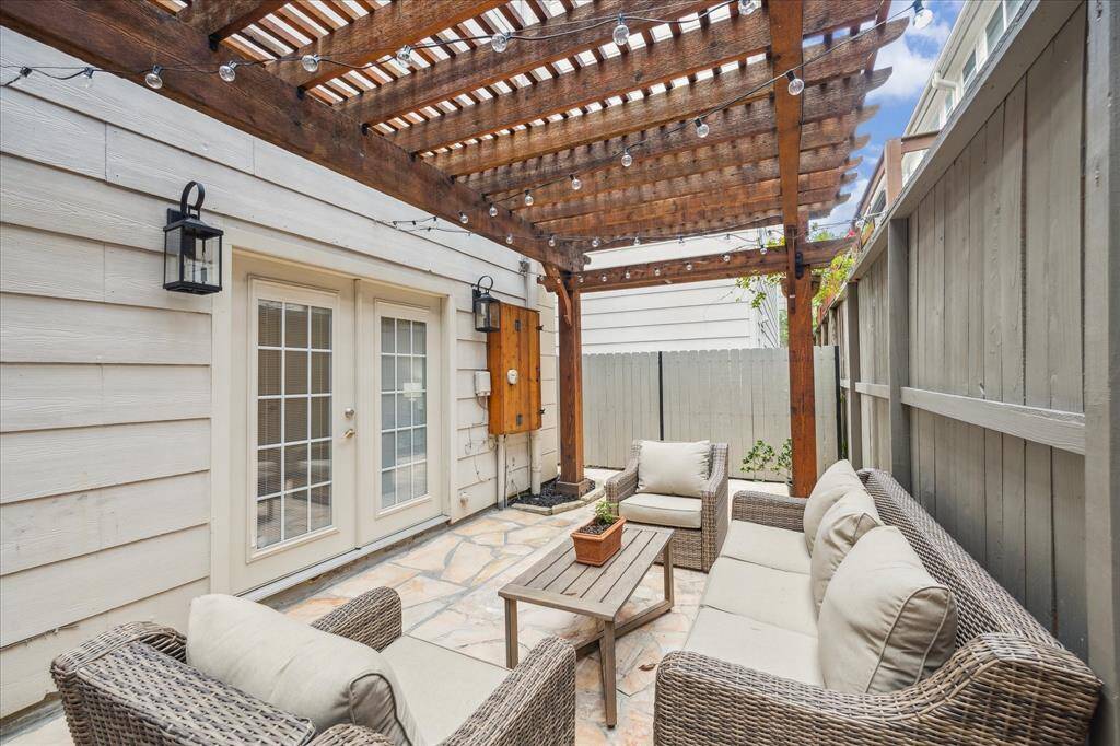Private side patio with cedar pergola is perfect for entertaining