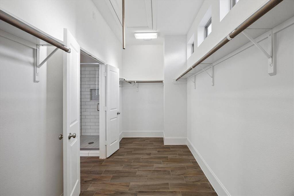 The expansive walk-in closet completes the suite with abundant storage, natural light, and plenty of space to stay organized in style—it's a dream come true for any wardrobe.
