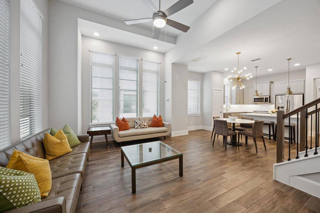 Perched on a desirable corner, this second-floor living space is bathed in natural light from multiple exposures. The open layout enhances the sense of space, creating a warm and inviting atmosphere perfect for relaxing or entertaining.