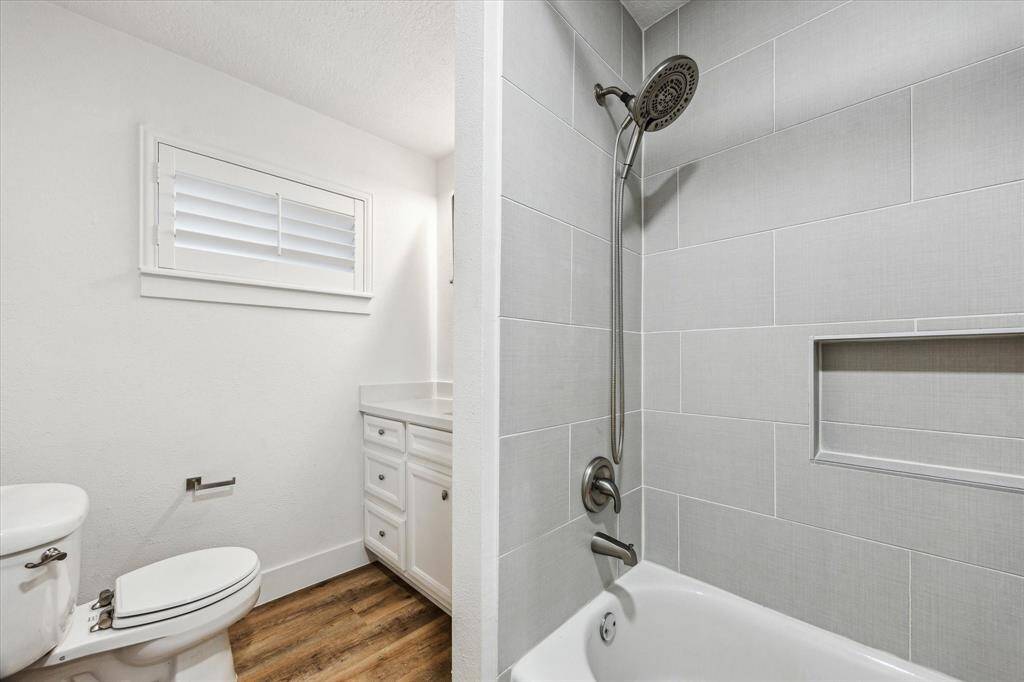 New Hardie backer and tile at hall bath with Schluter shower niche.