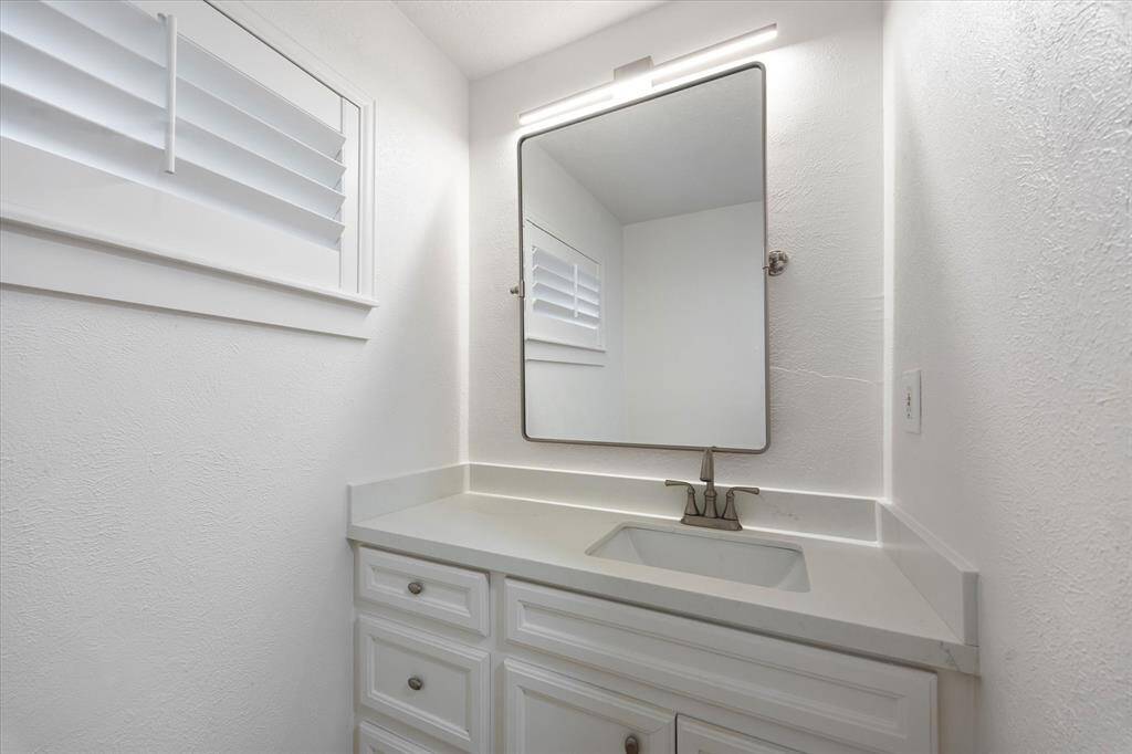 Quartz countertop. Brushed Nickle bath hardware and fixtures