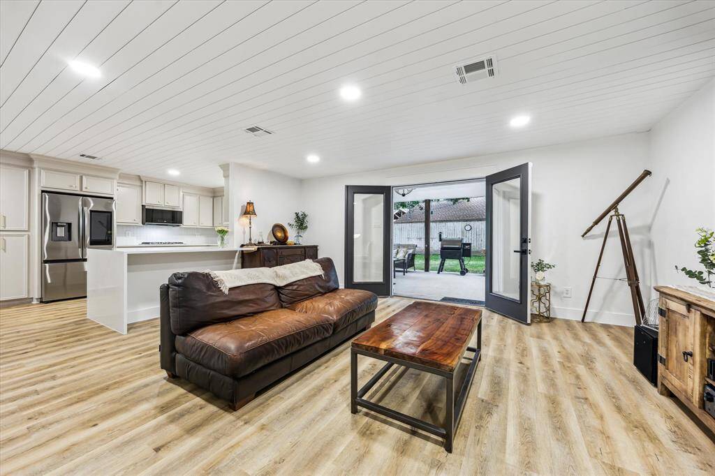 The completely redone Kitchen adjoins the large Family Room with its large glass doors to the deep covered back porch and big yard with French drains.