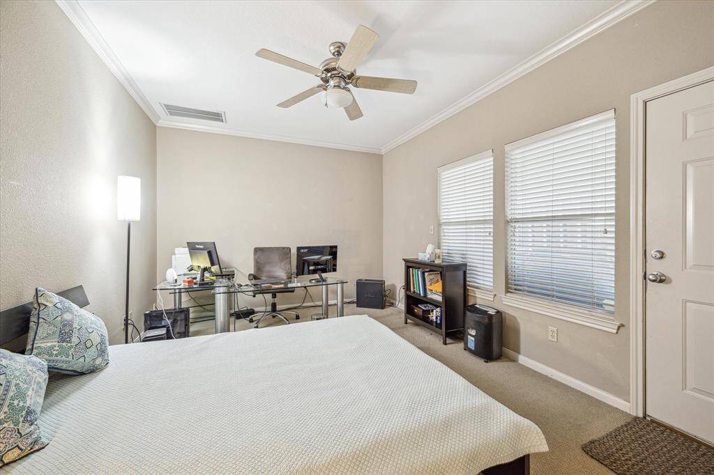 Secondary Bedroom One - 15 x 11:  Located on the first floor with private bath and access to private patio area.  Wall to wall carpet, baseboards, crown molding, walk-in closet and ceiling fan.