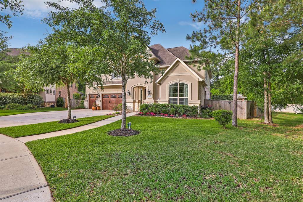 This charming home features a well-maintained front yard with lush greenery and mature trees. The house has a classic design with a welcoming entrance and a spacious driveway leading to a two-car garage. Ideal for those seeking a serene suburban setting.