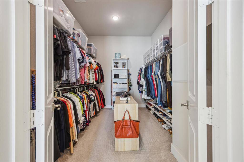 Look at all the space in the primary walk in closet.