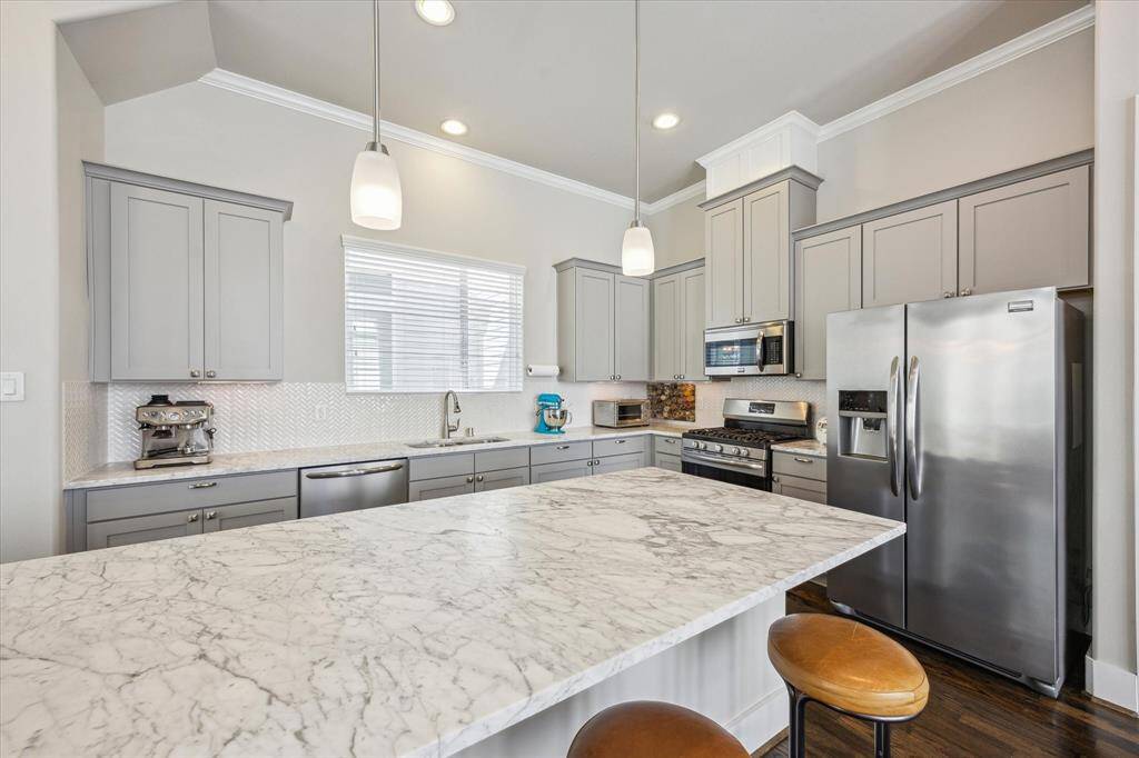 Gorgeous marble counter tops and stainless steel appliances are featured in this chef's kitchen.