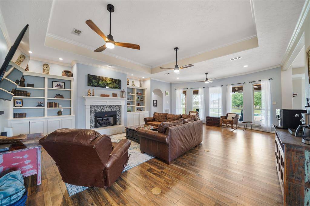 Texas sized living area with amazing views of the sprawling backyard and pool