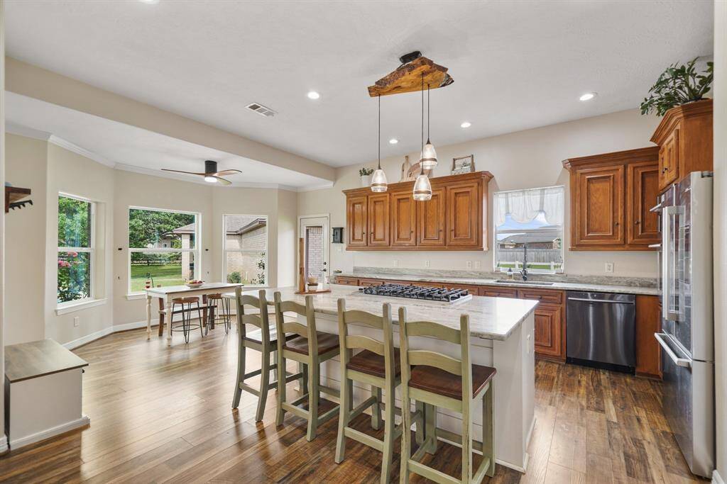 The gourmet kitchen hosts tons of natural light and great views of the pool and backyard.