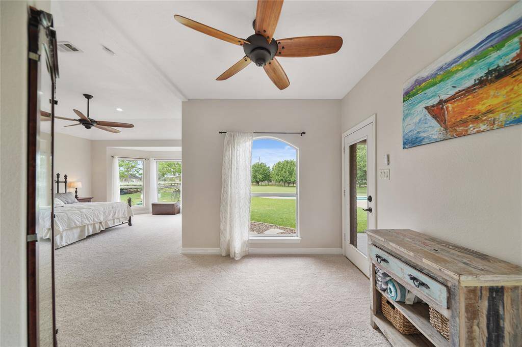 This primary suite is giant. You will fall in love with the separate sitting area and private exit to the pool.