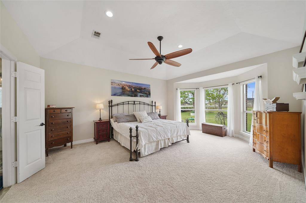 Lay in bed and enjoy the views of your sprawling acreage estate and listen to the water splashing in the pool.